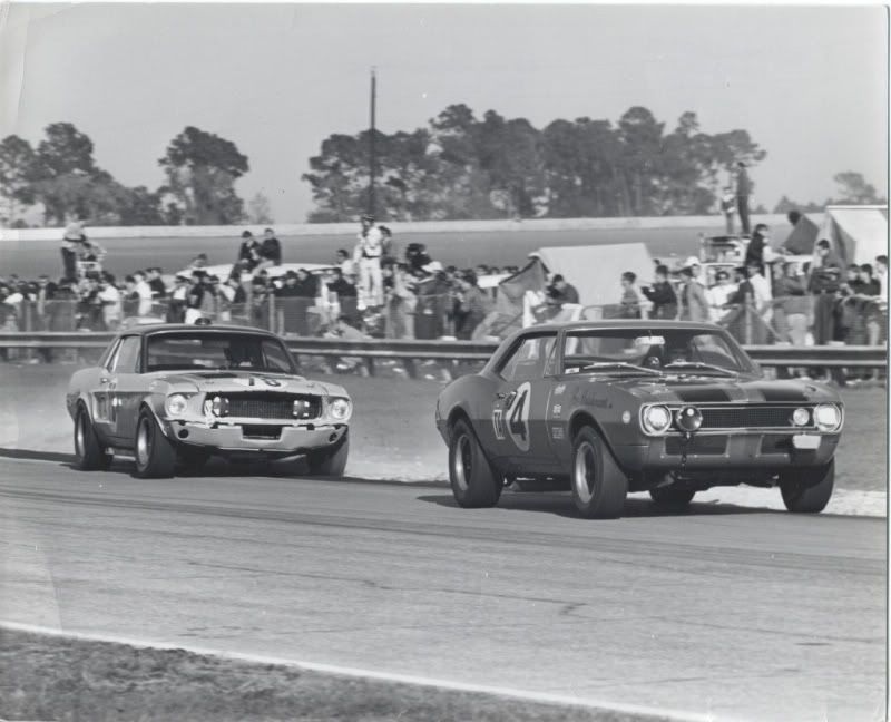  leads the Mustang of Sam Posey during the'68 Daytona 24Hour race